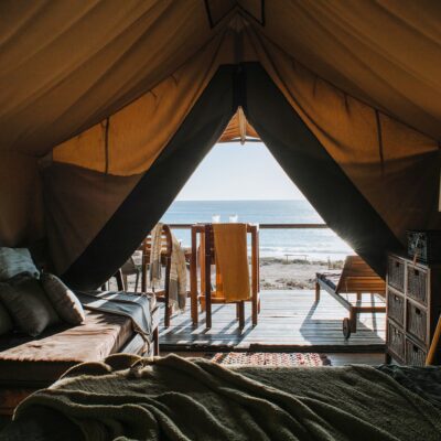 Cozy tent with bed and terrace on beach